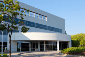 Modern building with large windows under a clear sky.