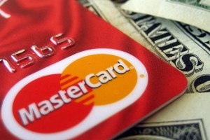 Close-up of a MasterCard credit card on top of US dollar bills.