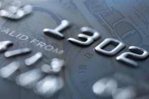 Close-up of embossed credit card numbers and details.